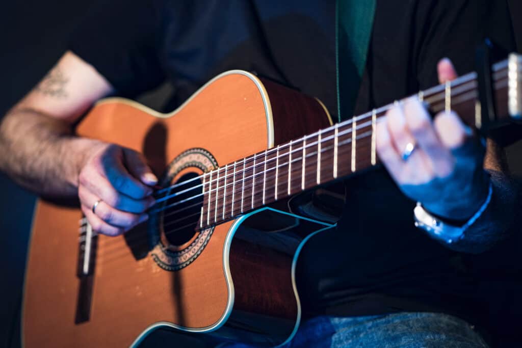 Playing nylon string store guitar with pick